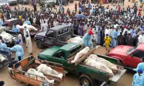 Trucks carry the wrapped bodies of people killed by suspected Boko Haram militants, during their funeral in Yobe, Nigeria (AP)