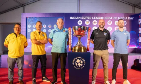 Managers of different ISL clubs pose with the trophy during media day in Kochi