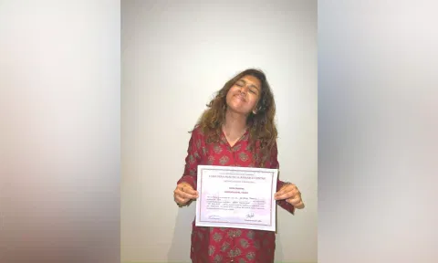 Keneeshaa Francis with her certificate from Lama Fera Practical Research Centre