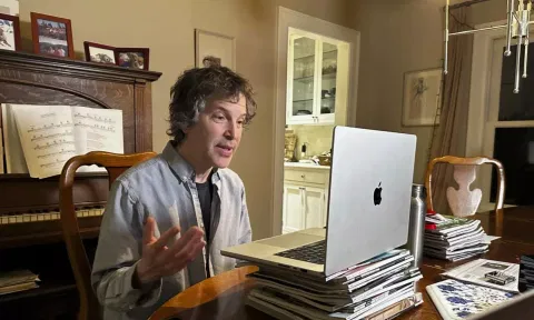American biochemist David Baker speaks to reporters at his home (AP)