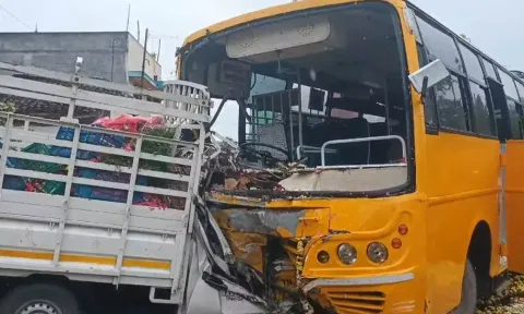 College bus and a mini truck standing after a collision