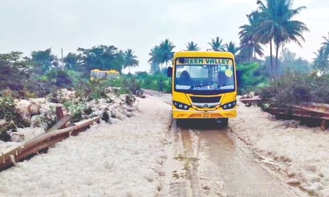 A school bus plying on the foam-cleared road
