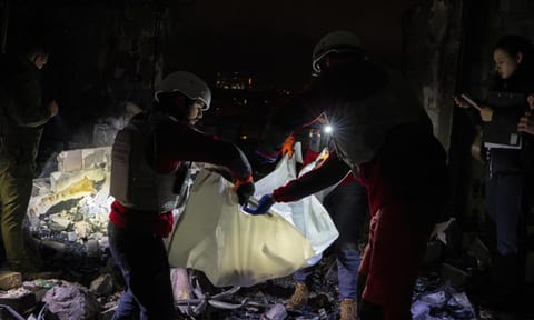A medical emergency team carry the body of a teenager who died after a Russian drone attack in Kyiv on Oct 26, 2024 (AP) 