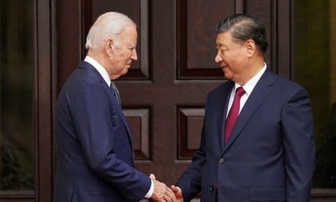 Joe Biden shaking hands with Xi Jinping (AP)