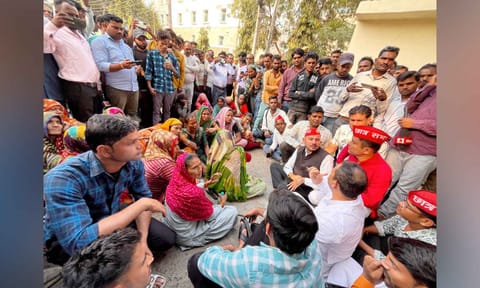 Family members of victims wait at the Maharani Laxmi Bai Medical College, where a fire broke out on Friday killing at least 10 newborns, in Jhansi district (PTI) 
