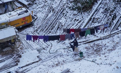 A woman dries clothes in sun after fresh snowfall in Shimla, Himachal Pradesh, Monday, Dec. 9, 2024 (PTI) 