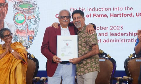 Kasi Viswanathan and K Srikkanth onstage with the special award plaque 