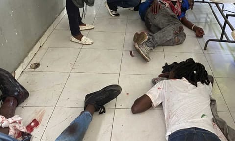 Journalists lie wounded after being shot by armed gangs at the general hospital in Port-au-Prince, Haiti (AP) 