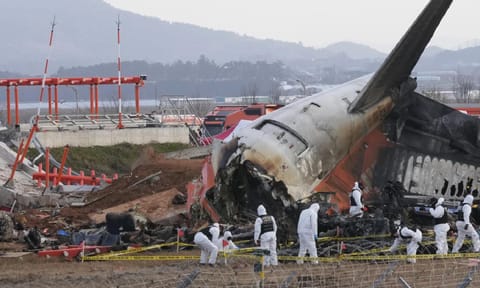 Rescue team members work at the site of a plane crash at Muan International Airport in Muan, South Korea, Tuesday, Dec 31,2024 (AP) 