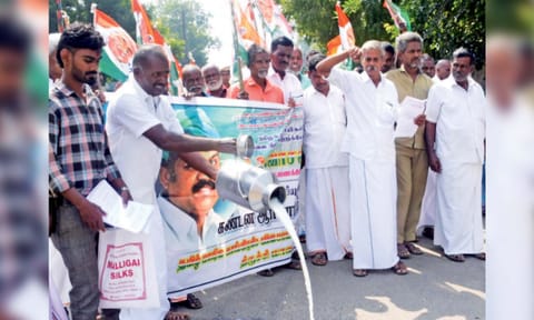 Farmers spill milk on road in Tiruchy on Monday 