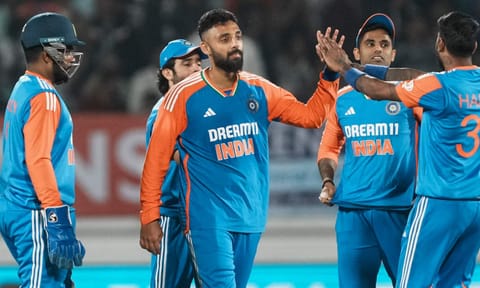 Varun Chakravarthy with teammates celebrates the wicket of England's Jofra Archer during the third T20 cricket match between India and England 