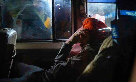 Indians deported from the U.S. being escorted by the police as they leave the airport upon their arrival, in Amritsar, early Sunday (PTI) 