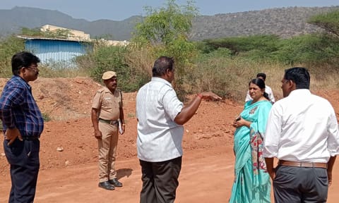 Forest officials and authorities examine the spot where a leopard was seen