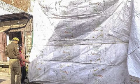 The Shahi Jama Masjid being covered in tarpaulin as prevention against possible holi colour ahead of the celebration, in Sambhal, Uttar Pradesh, Credit: PTI Photo