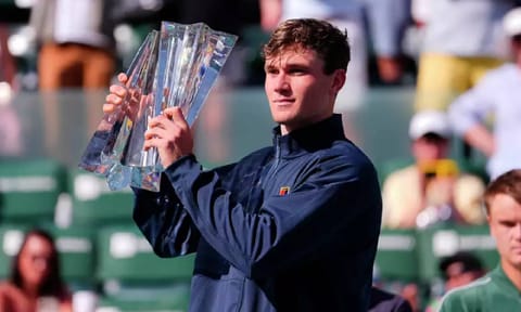 Jack Draper, of Britain, holds the winner's trophy at the BNP Paribas Open tennis tournament Sunday, March 16, 2025, in Indian Wells, Calif (AP)