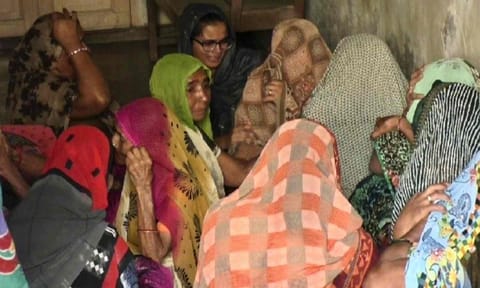 Family members and relatives mourn outside the residence of Pradipkumar Patel and his daughter who were shot dead at a convenience store in the US state of Virginia, in Mehsana district, Gujarat (PTI)