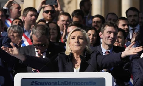 French far-right leader Marine Le Pen delivers her speech during the French far-right party national rally near the parliament in Paris (AP)