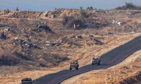  Israeli military vehicles move inside the Gaza Strip, as seen from southern Israel (AP)