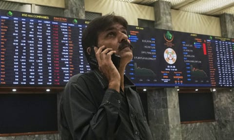 An investor looks on indexes and benchmark 100 index at the Pakistan stock Exchange (PSE), in Karachi, Pakistan (AP) 