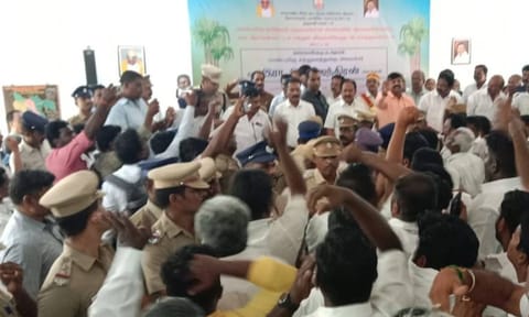 Police personnel removing two AIADMK MLAs and their supporters from the meeting hall in Dharmapuri 