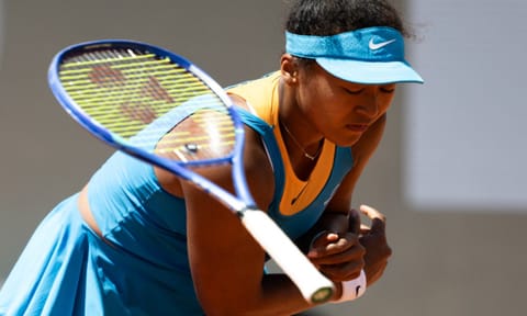 Naomi Osaka reacts after losing 