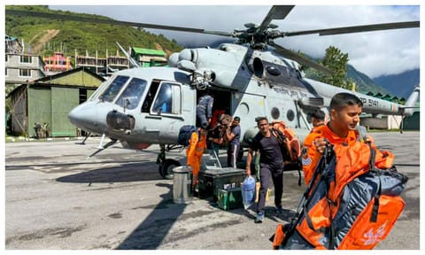 NDRF personnel and others during a rescue operation of stranded tourists stuck after multiple landslides triggered by heavy rain, in Mangan district, Sikkim (PTI)