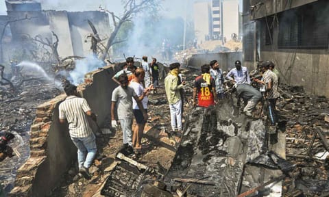 People stand near the debris of the Air India plane that crashed moments after taking off from the airport, in Ahmedabad, Thursday, June 12, 2025 (PTI) 