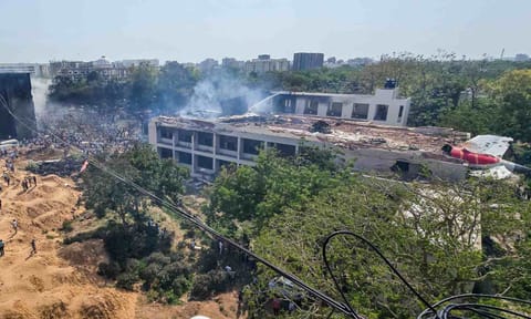 People gather at the site after an Air India plane crashed moments after taking off from the airport, in Ahmedabad (PTI) 