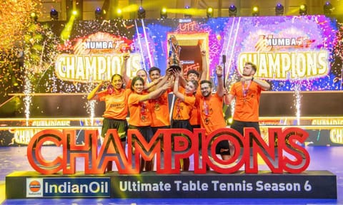 U Mumba TT players celebrate with the trophy