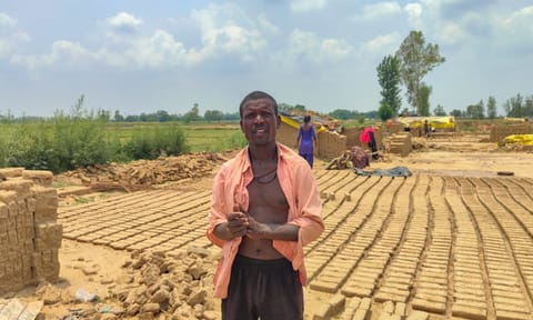 A migrant worker stands over stacks of bricks ruined by rain at a brick kiln, in Aligarh district, Uttar Pradesh (PTI)