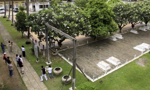 Tourists take their tour at the grave side in the former Pol Pot's notorious S-21 prison, known Tuol Sleng genocide museum in Phnom Penh, Cambodia (AP) 