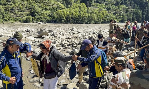 A person uses a satellite-based calling facility set up by the Indian Army to communicate with his family, at cloudburst-hit Uttarkashi (PTI) 