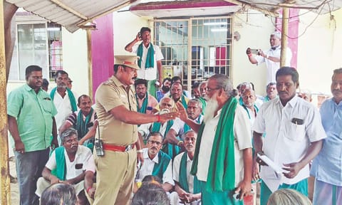 A section of the farmers protesting against the alleged usurping of temple land, at the RDO office in Thanjavur on Friday