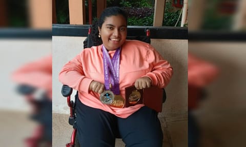 Sharon Rachel Aby with the medals she won 