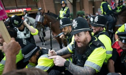 Mounted police officers scuffle with demonstrators during a protest (AP) 