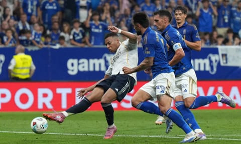 Kylian Mbappe takes a shot to score Madrid's opener 