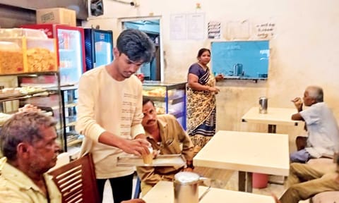 Haripriyan serving customers at the bakery where he works 