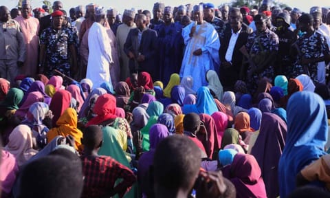 BOMO state Governor Babagana Zulum, center back, speaks to people affected by a Boko Haram attack, as he visits the area in Darul Jamal, Nigeria (AP) 