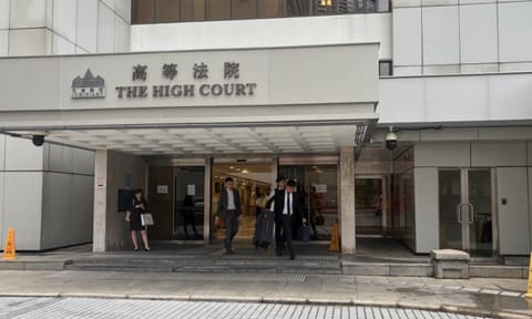 People walk out of the Hong Kong High Court in Admiralty, Hong Kong (AP)