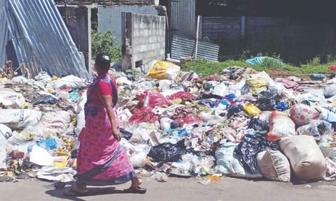 Wet waste and plastic waste lie scattered on vacant land at Ramanuja Iyer Street in Old Washermenpet
