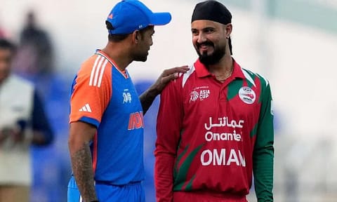 India's captain Suryakumar Yadav, left, talks with Oman's Captain Jatinder Singh before the toss for their Asia Cup 2025 clash in Abu Dhabi. Photo: AP