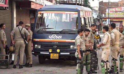 Police personnel keep a vigil amid tight security after recent clashes, in Bareilly (PTI) 