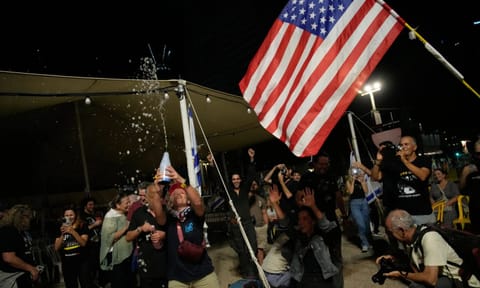 People react as they celebrate following the announcement that Israel and Hamas have agreed to the first phase of a peace plan 
