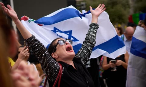People react as they celebrate following the announcement that Israel and Hamas have agreed to the first phase of a peace plan (AP) 