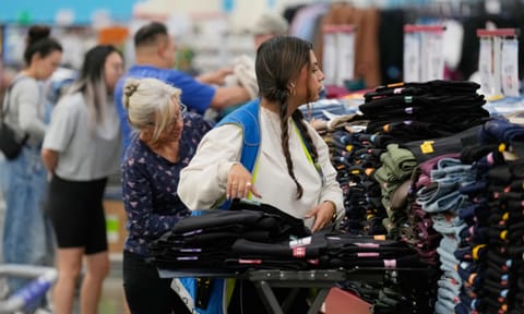 A worker stocks a display of clothing at Sam's Club (Photo: AP)