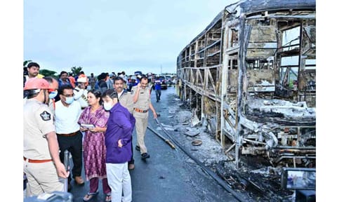 Police personnel investigate the spot after a Hyderabad-bound private bus caught fire following a collision with a two-wheeler, near Chinnatekur in Kurnool district, Andhra Pradesh, Friday, Oct. 24, 2025. At least 12 people were killed in the accident (PTI) 