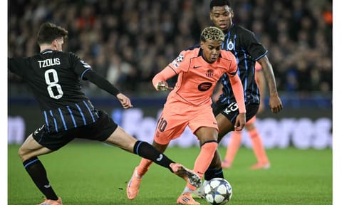 Lamine Yamal dribbles past Club Brugge players during a recent match 