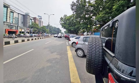 Cars occupying most of a lane on Third Avenue in Anna Nagar 