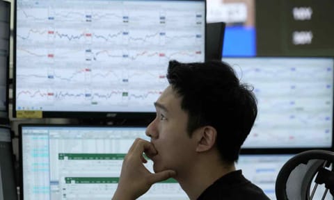 A currency trader watches monitors at the foreign exchange dealing room of the Hana Bank headquarters in Seoul, South Korea, Friday, Nov. 14, 2025 (AP) 