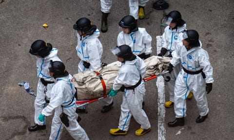 Police remove what appears to be a body bag from the site of a deadly Wednesday fire at Wang Fuk Court, a residential estate in the Tai Po district of Hong Kong’s New Territories on Sunday, Nov. 30, 2025. (AP)